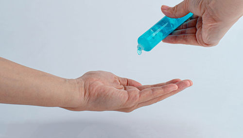 Close-up of hands holding over white background
