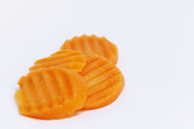 Close-up of orange slice over white background