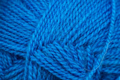 Texture of blue soft woolen threads for knitting closeup.