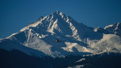 Scenic view of snowcapped mountain against blue sky