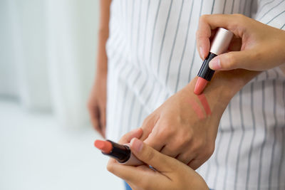 Midsection of woman using mobile phone