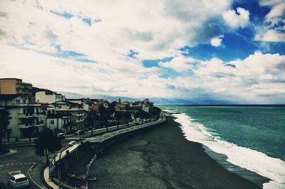 Panoramic view of beach and buildings against sky