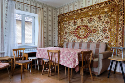 Old soviet  poor interior in khruschev house. aged sideboard.  shabby floor. tattered wallpaper. 