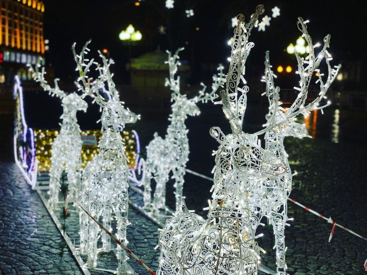 CLOSE-UP OF CHRISTMAS DECORATION HANGING IN SNOW AT NIGHT