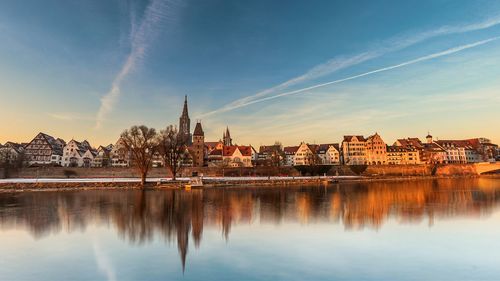 View of city at waterfront during sunset