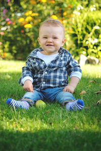 Baby boy sitting on grass