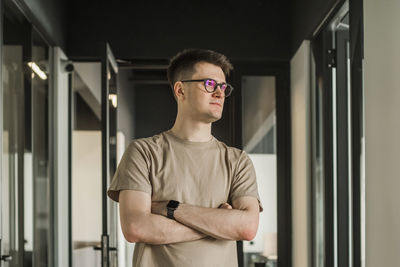 Portrait of young man wearing sunglasses standing in gym