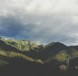 Scenic view of mountains against cloudy sky