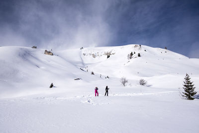 People on snowcapped mountain