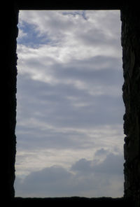 Low angle view of silhouette trees against sky