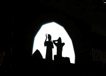 Silhouette of people in the dark