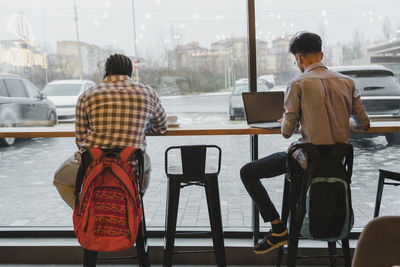 Young freelancers working at table in cafe