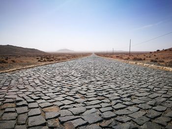 Surface level of road against clear sky