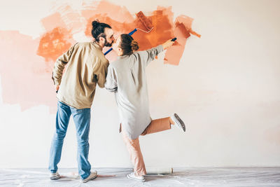 Full length of couple standing on beach