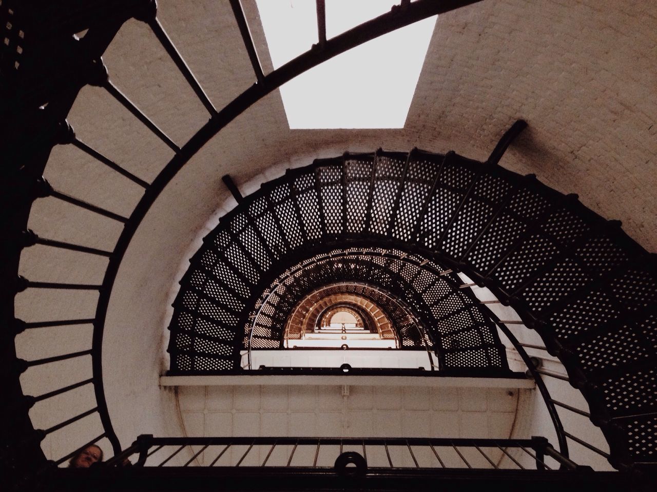 architecture, built structure, staircase, steps and staircases, indoors, steps, spiral staircase, low angle view, railing, building exterior, spiral, arch, directly below, building, stairs, pattern, ceiling, window, architectural feature, high angle view