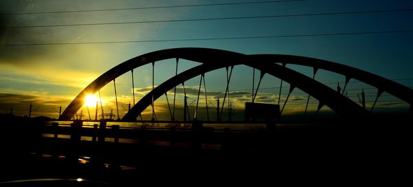 Silhouette of bridge against sky during sunset