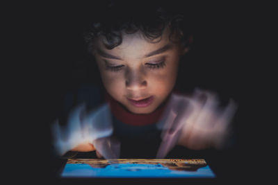 Young boy playing games on tablet