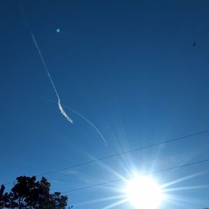 Low angle view of vapor trails in sky