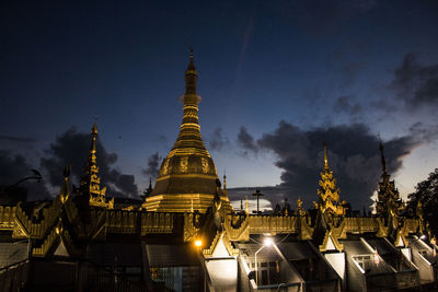 Panoramic view of illuminated buildings against sky at night