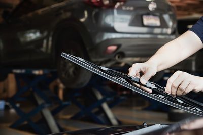 Cropped hands of man working on car