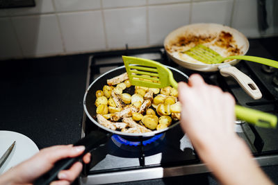 Cropped hands of woman preparing food in kitchen