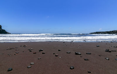 Scenic view of beach against clear sky