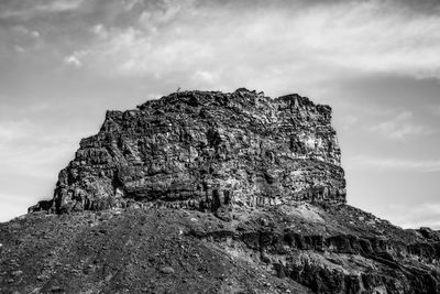 Low angle view of rock formation against sky