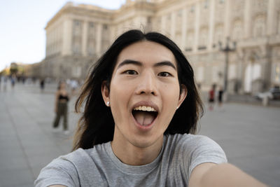 Selfie of taiwanese boy having fun in madrid city