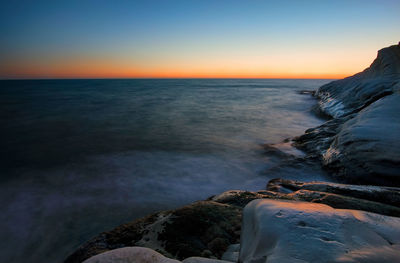 Scenic view of sea against clear sky during sunset