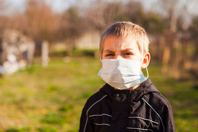 Portrait of boy standing outdoors