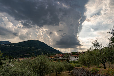 Panoramic view of buildings and mountains against sky