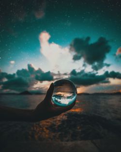 Close-up of reflection in sea against sky