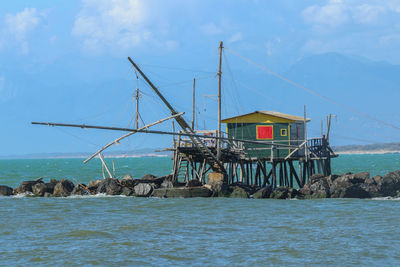 Scenic view of sea by building against sky