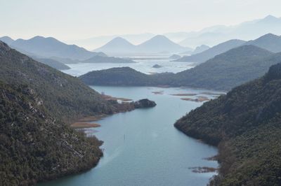 Scenic view of lake and mountains against sky