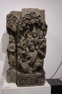 Close-up of buddha statue against built structure