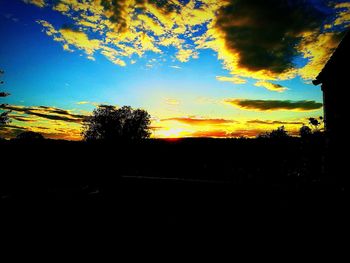 Silhouette landscape against sky at sunset