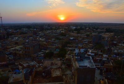 Aerial view of cityscape against sky during sunset