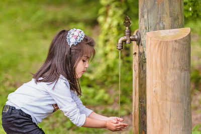 Girl drinking water at park