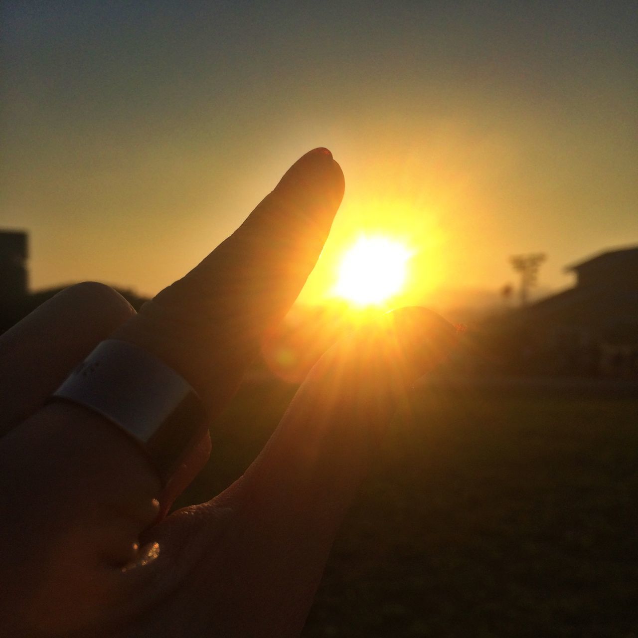 person, sun, part of, sunset, holding, cropped, human finger, unrecognizable person, sunlight, lens flare, sky, sunbeam, lifestyles, leisure activity, personal perspective, orange color, close-up