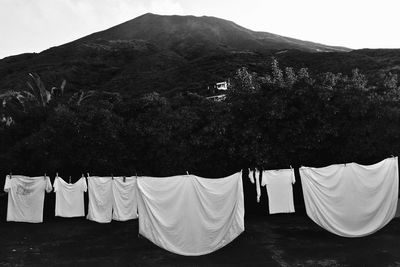 Clothes drying on clothesline against mountain