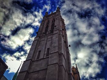 Low angle view of tower against cloudy sky