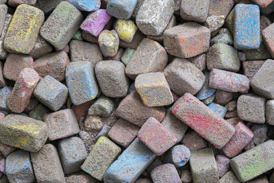 Colored pieces of chalk. broken pieces of colored dirty chalk