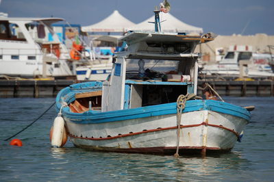 Boats moored at harbor