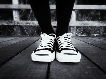 Low section of woman standing on tiled floor