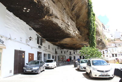 Cars parked on street by buildings in city