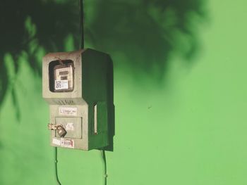 Close-up of telephone booth on wall