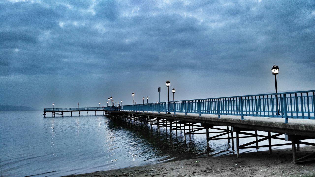 water, sky, sea, pier, cloud - sky, built structure, cloudy, tranquility, railing, nature, architecture, cloud, tranquil scene, horizon over water, scenics, overcast, bird, beauty in nature, day, beach