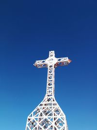 Low angle view of sculpture against clear blue sky