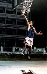 Young woman jumping on street