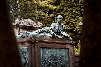 Low angle view of statue against trees